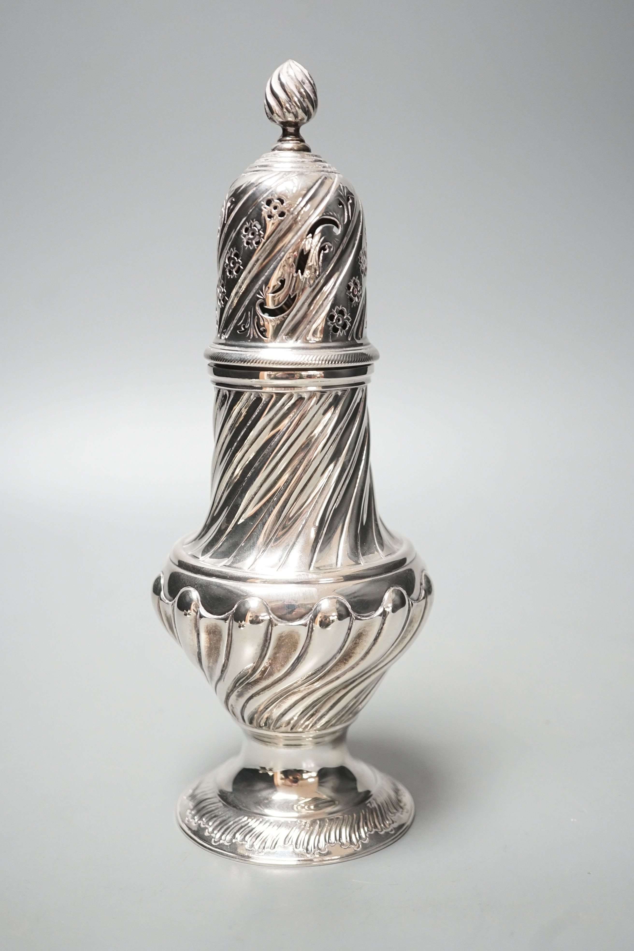 A large Victorian repousse silver sugar caster, London, 1887, 22.7cm, 8.5oz.